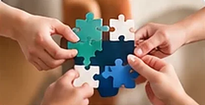 Hands joining puzzle pieces together